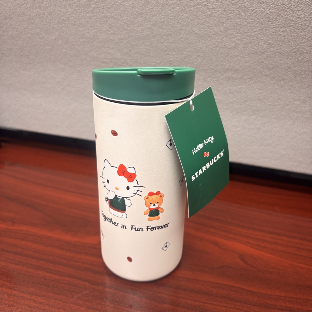 Starbucks White Tumbler with Green Lid and Hello Kitty Design